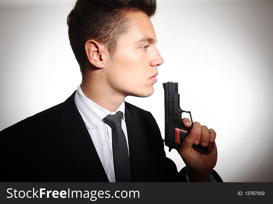 Young business mann hold a gun. Young business mann hold a gun