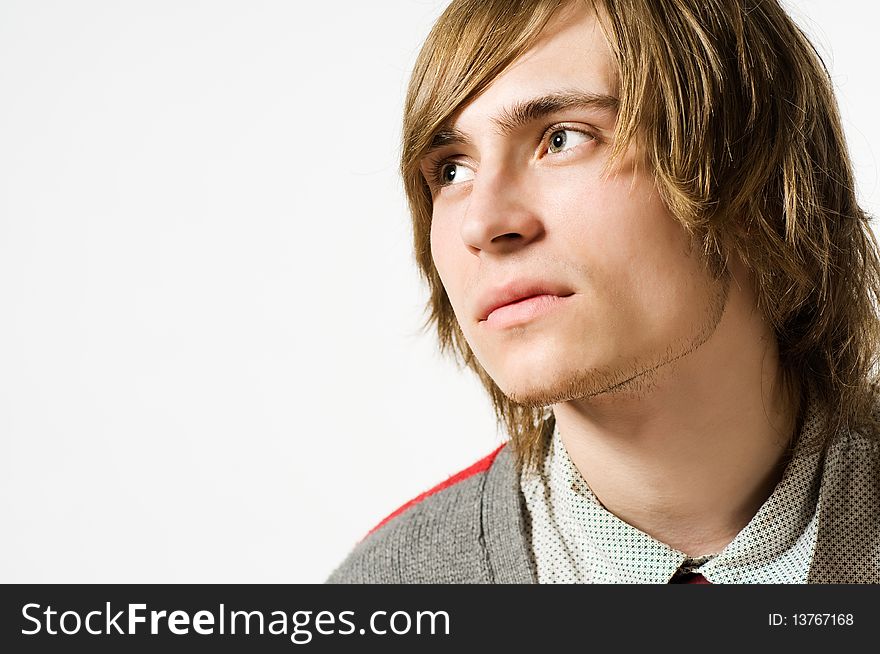 Close-up portrait of young man on light grey background