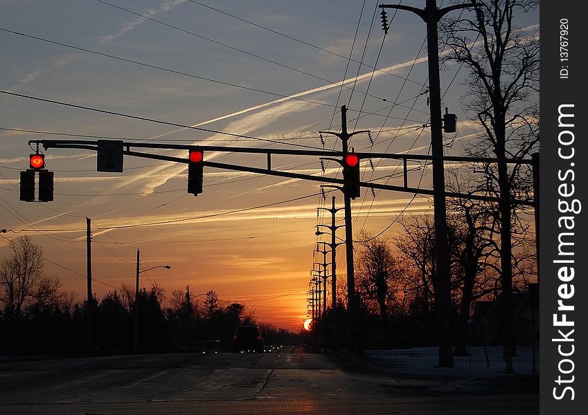 Streetlight Sunset with oncoming traffic