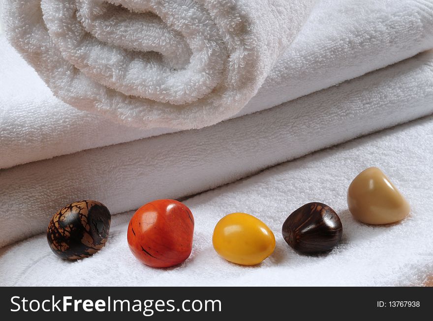 White towels with colorful stones. White towels with colorful stones.