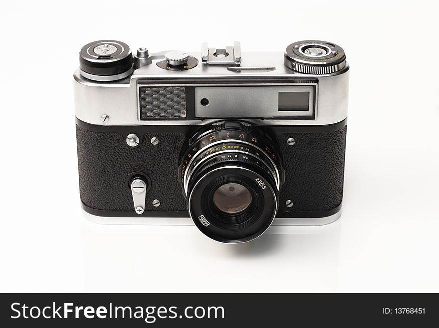 Old black silver camera on a white background