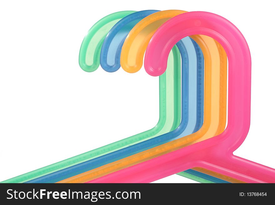 Coloured plastic hangers on a white background. Coloured plastic hangers on a white background