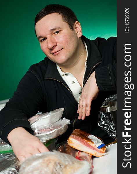 Man in heap of the food products. Man in heap of the food products.