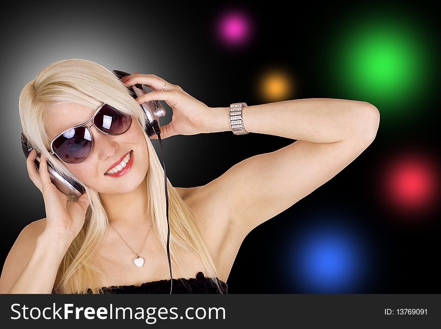 Beautiful blond girl wearing headphones. Beautiful blond girl wearing headphones