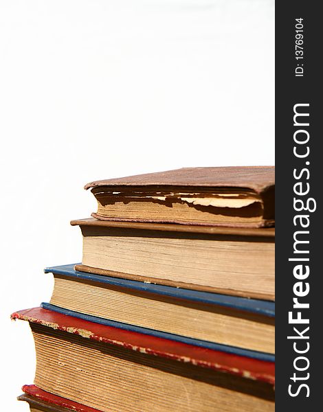 Stack of old books on white background