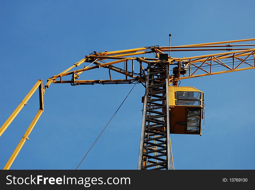 A construction crane with a blue sky. A construction crane with a blue sky