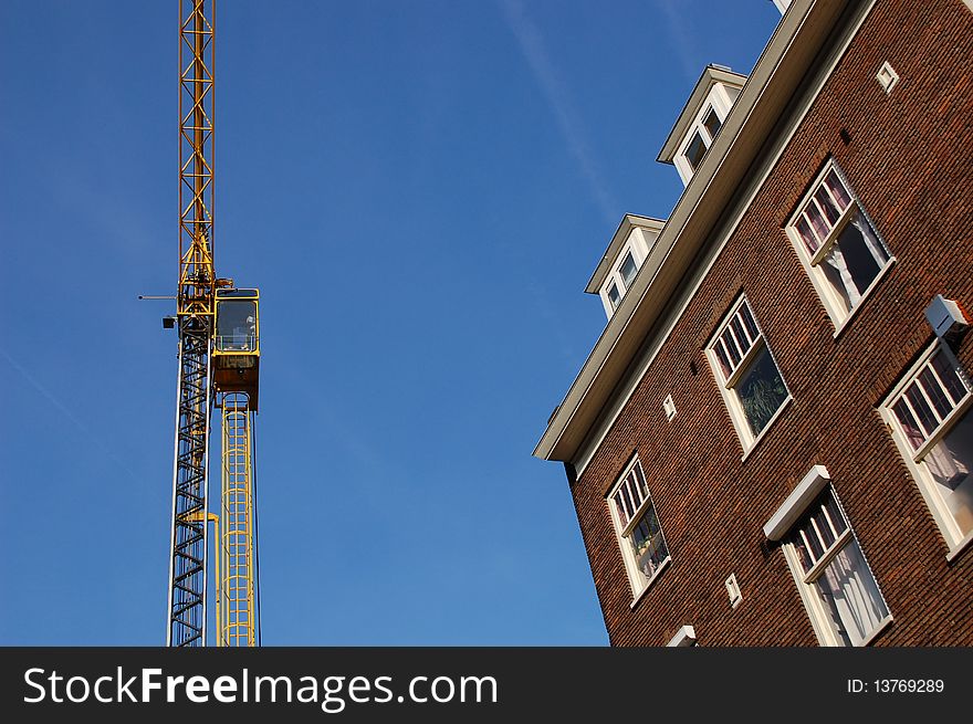 Crane with houses at a construction site. Crane with houses at a construction site
