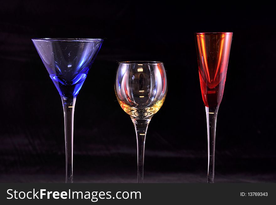 3 drink glasses in primary colors, black. 3 drink glasses in primary colors, black