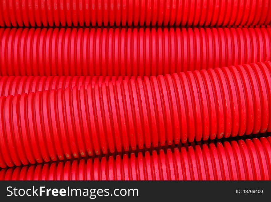 Red plastic pipes at a construction site