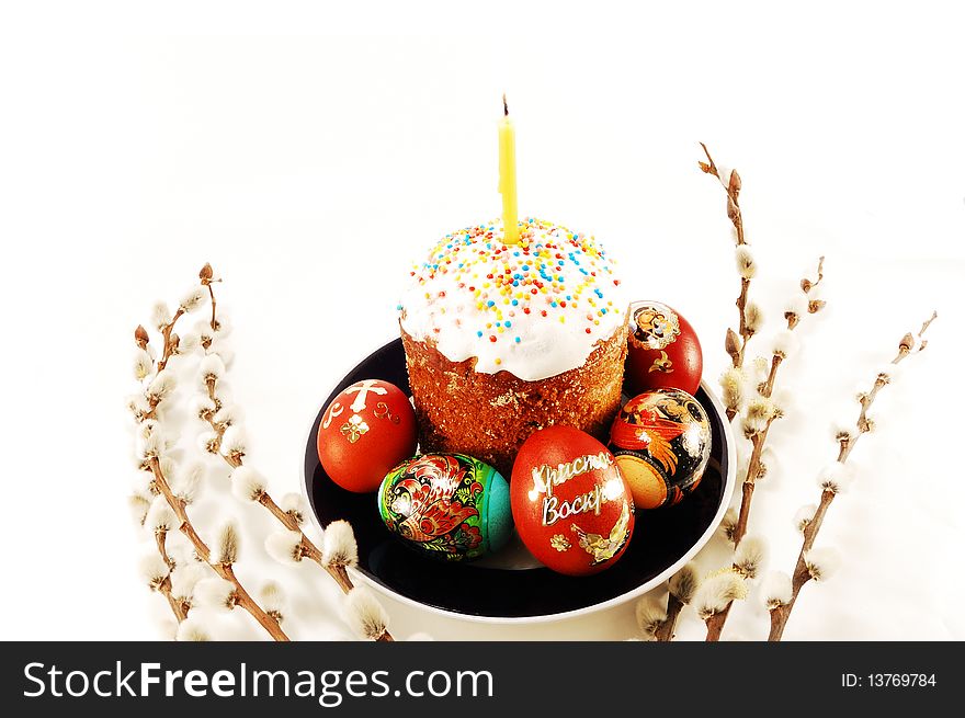 Easter cake with colored eggs and willow branches on a white background. Easter cake with colored eggs and willow branches on a white background