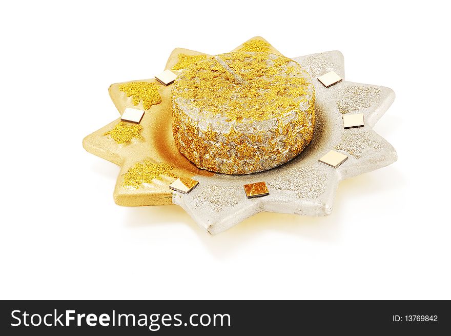 Ceramic candle holder with a candle in the form of the sun with sparkles isolated on a white background. Ceramic candle holder with a candle in the form of the sun with sparkles isolated on a white background