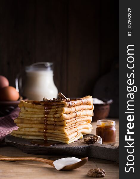 Tasty crepes with Raspberry jam. French crepes, russian or ukrainian blini or blintzes with fresh Raspberry on blue plate. Maslenitsa holiday food.