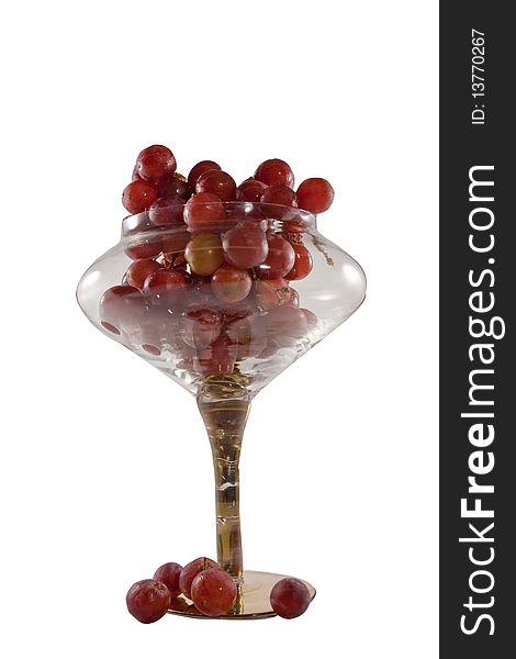 Fresh red grapes in clear crystal bowl on a white background. Fresh red grapes in clear crystal bowl on a white background.