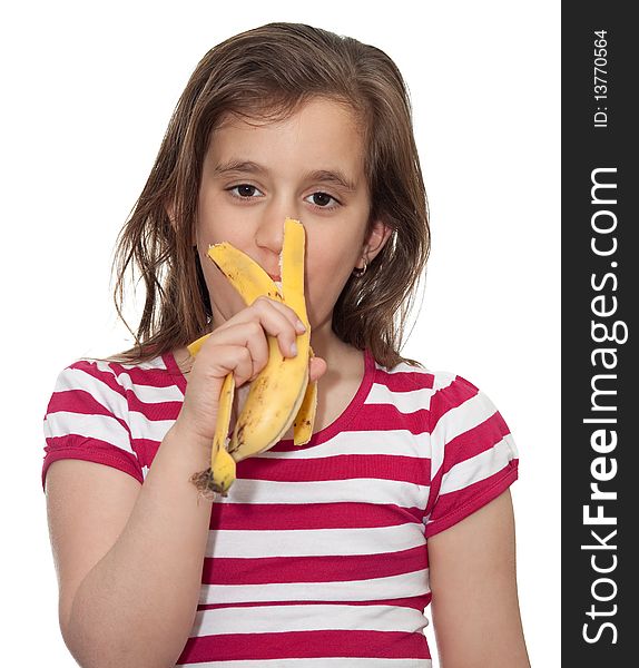Young girl eating a banana in a white background