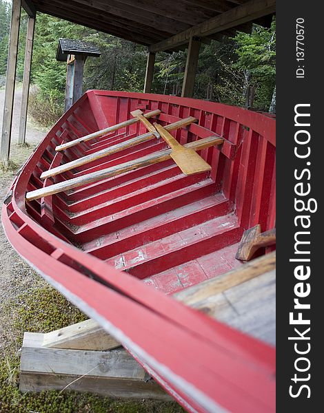 A long canoe on display on a hiking trail