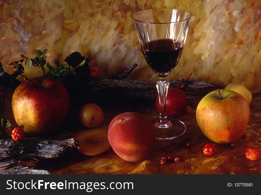 Red wine and fruits isolated on painted background