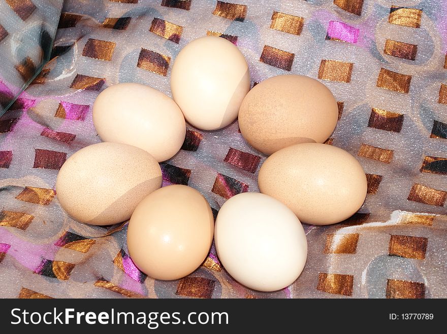 Chicken eggs, laid out a ring, a colored fabric
