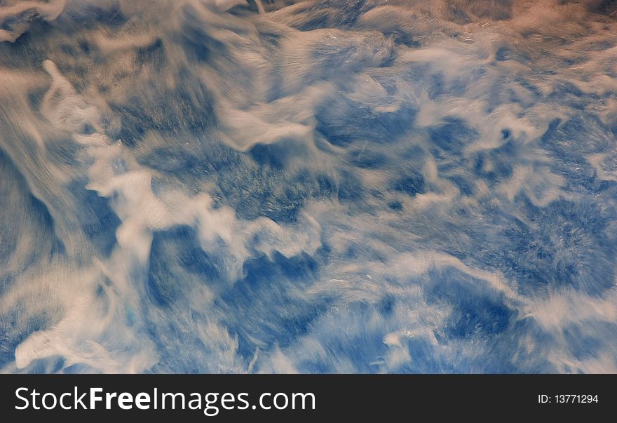 Blurry water surface with foam