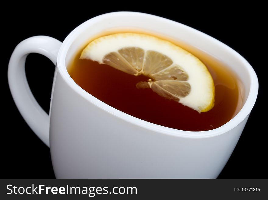 Close-up cup of tea with lemon, isolated on black. Close-up cup of tea with lemon, isolated on black