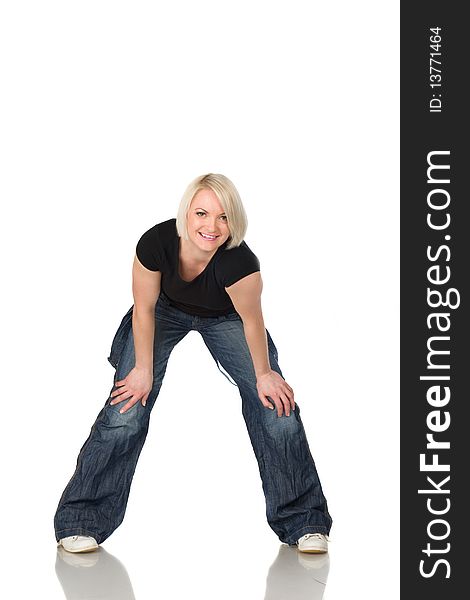 Blonde woman in jeans and a dark shirt, smiling and stay. Isolated on the white. Blonde woman in jeans and a dark shirt, smiling and stay. Isolated on the white