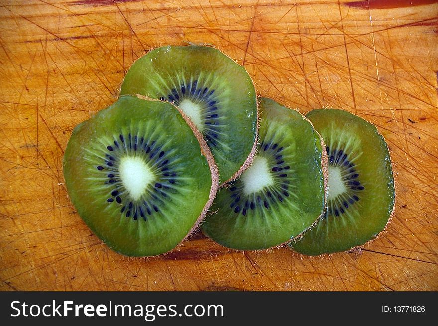 Close up of kiwi fruit slices on wooden background