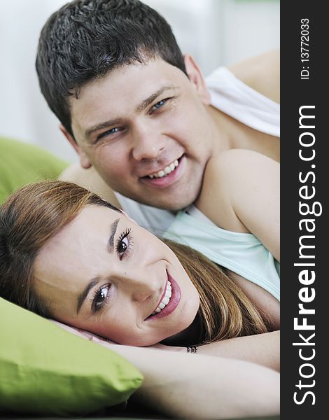 Happy young couple in bed at morning