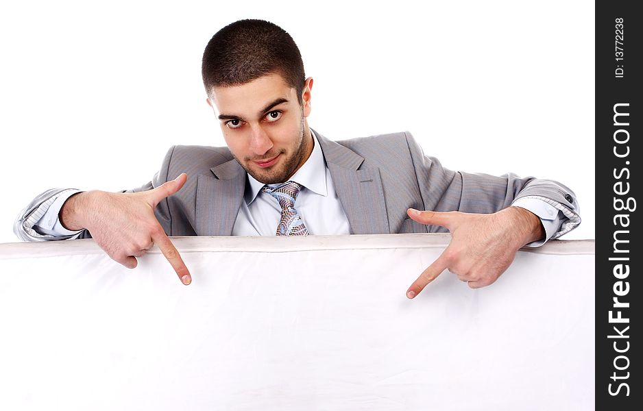 Young businessman in suit with white empty placard. Young businessman in suit with white empty placard