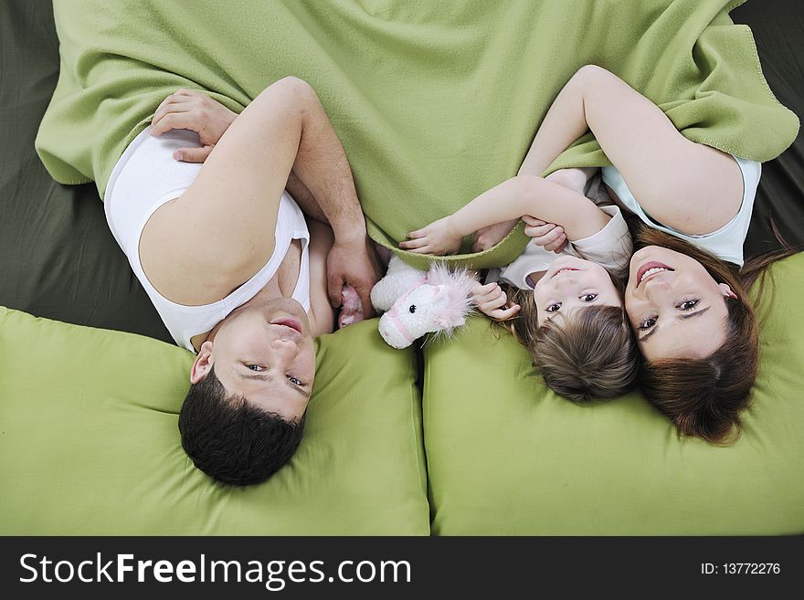 Happy Family Relaxing In Bed