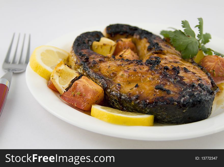 Broiled salmon steak with roasted tomatoes