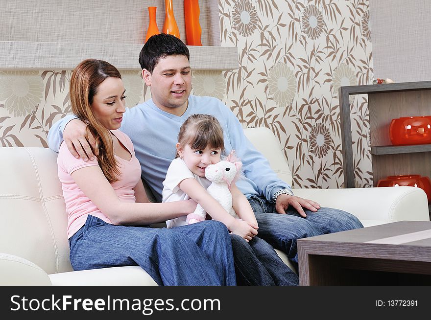 Happy youg family relaxing in modern livingroom at home. Happy youg family relaxing in modern livingroom at home