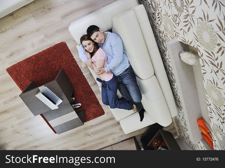 Happy young couple relax at home in modern and bright living room. Happy young couple relax at home in modern and bright living room
