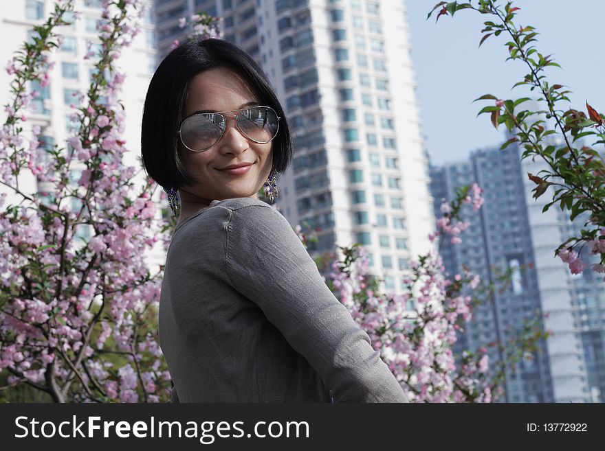 Asian girl looking cool wearing glasses, flower background in spring. Asian girl looking cool wearing glasses, flower background in spring.