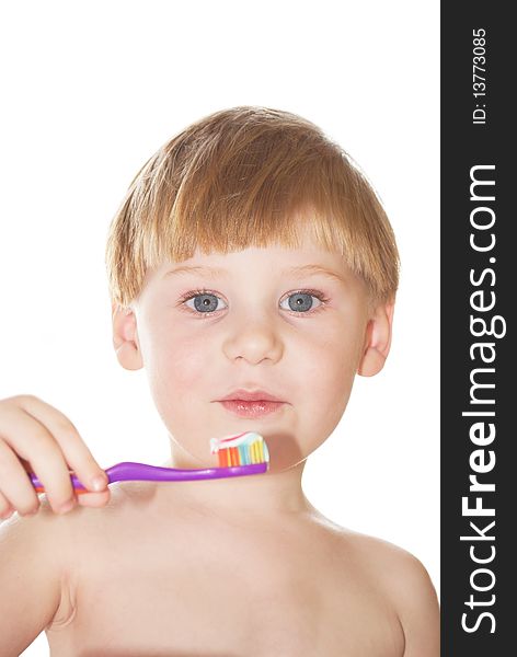 The little boy cleans a teeth on a white background. The little boy cleans a teeth on a white background