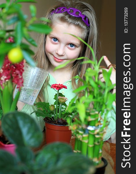 An image of a nice girl watering flowers