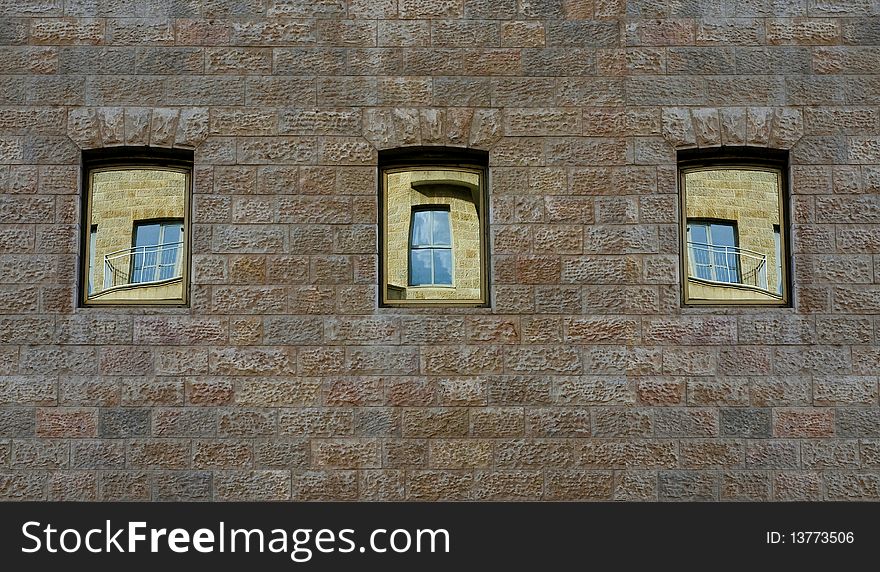 Three windows in which the other three windows and a sky are being reflected. Three windows in which the other three windows and a sky are being reflected