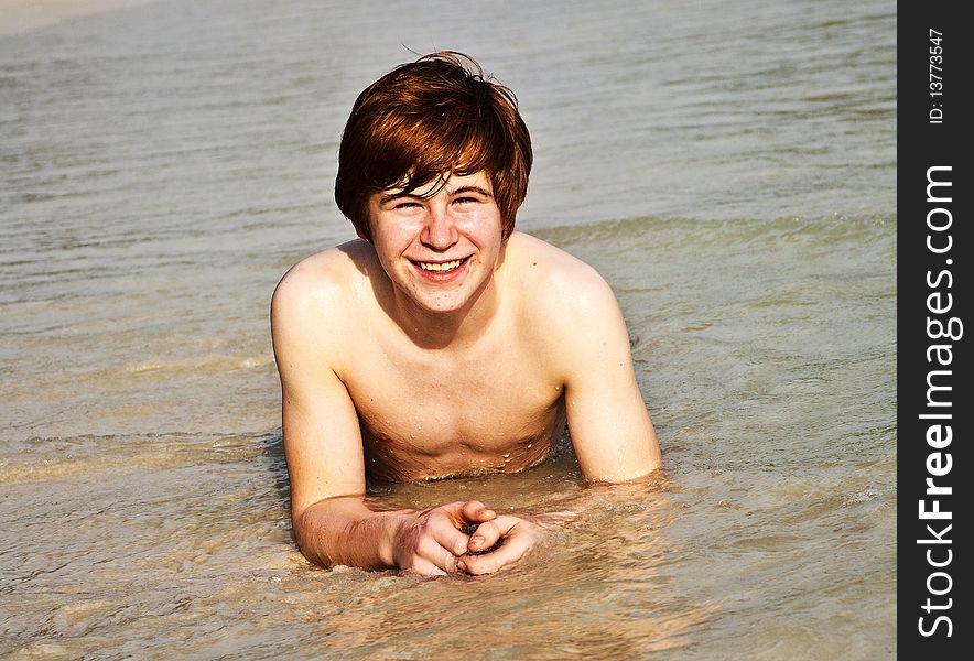 Happy boy with red hair is enjoying the beautiful beach. Happy boy with red hair is enjoying the beautiful beach