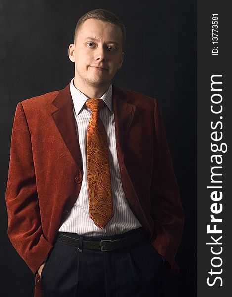 Young, elegant businessman, calm and confident face expression. Wearing shirt, tie and red suit. Young, elegant businessman, calm and confident face expression. Wearing shirt, tie and red suit.