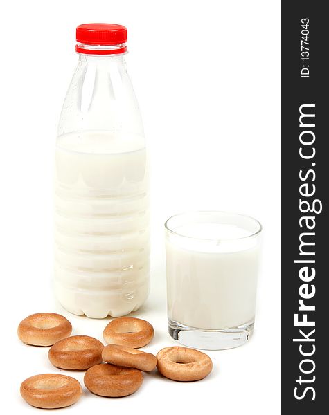 Bottle and glass milk with bagel on white background