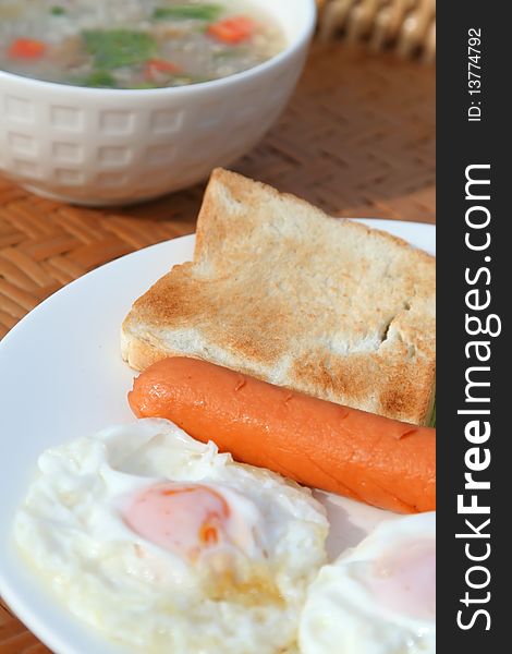 Delicious breakfast with bread sausage fried egg Cucumber and tomatoes