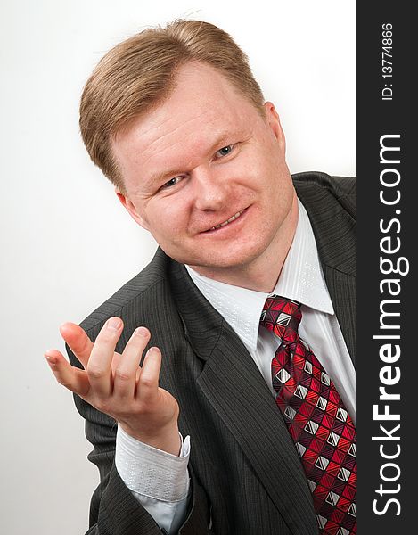 The man in a grey suit and a red tie in good mood. It the successful businessman. The man in a grey suit and a red tie in good mood. It the successful businessman.