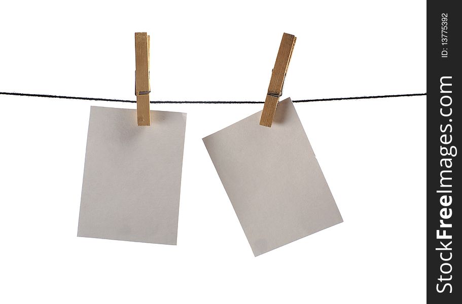 Photo paper hanging on several pins. Image isolated on white background. Photo paper hanging on several pins. Image isolated on white background.