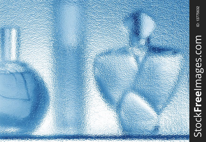 Fragrances  silhouette behind glass in blue tone. Fragrances  silhouette behind glass in blue tone