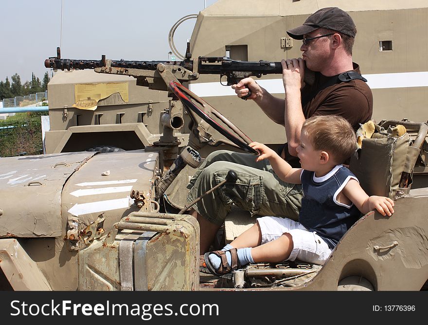 Men's game. Father and son at the Museum of tanks