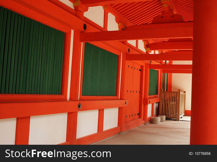 Red, white and green covered walk way at a traditional Japanese Shinto Temple. Red, white and green covered walk way at a traditional Japanese Shinto Temple.