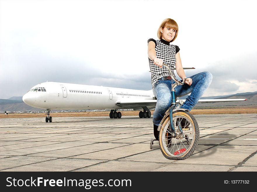 Young woman on bike on a runway