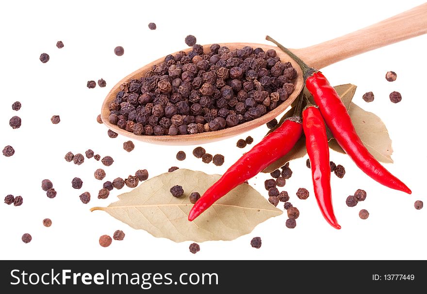 Spices in a wooden spoon isolated on white background