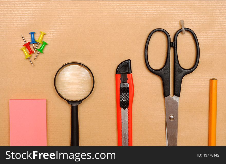 Office objects over brown paper background