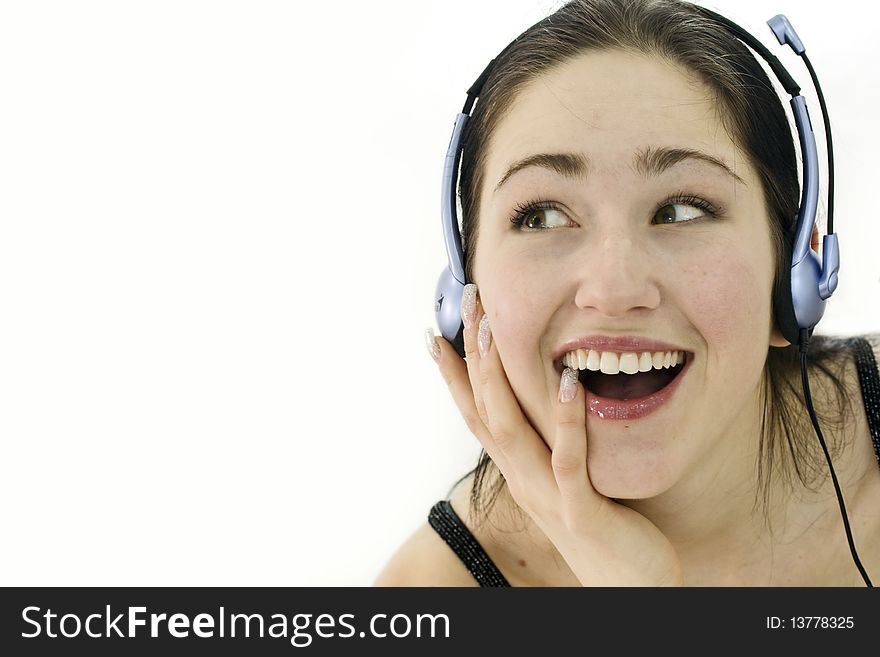 Happy woman in headphones over white. Studio shot