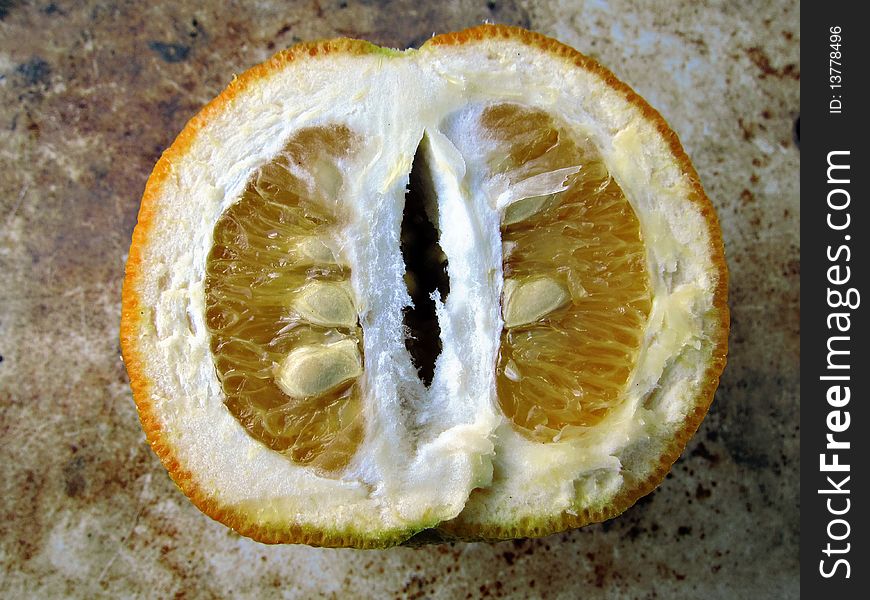 Half orange with seeds on a rough background