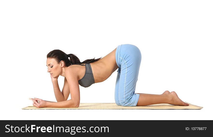 Young and attractive woman doing stretching exercise. Image isolated on a white background. Young and attractive woman doing stretching exercise. Image isolated on a white background.